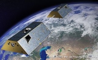 This artist illustration shows a pair of Gravity Recovery and Climate Experiment Follow-on (GRACE-FO) satellites in space over the Earth.