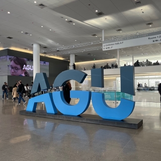 A three-dimensional AGU logo welcomes attendees to the conference center.