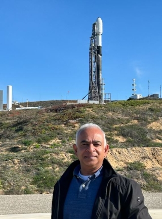 Desai stands before the SpaceX Falcon 9 rocket at Vandenberg Space Force Base in California the day before launch (December 14, 2022). 