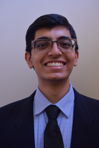 Headshot of Abhinav wearing a suit and tie.