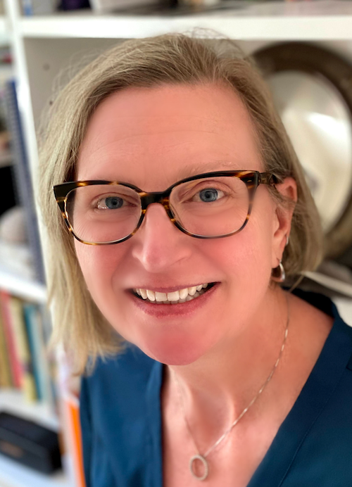 Headshot of Dr. Chelle Gentemann sitting in front of a bookcase.